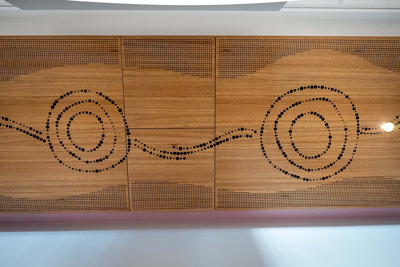 Artwork along ceiling representing Seven Sisters Songline and Tjukurpa.