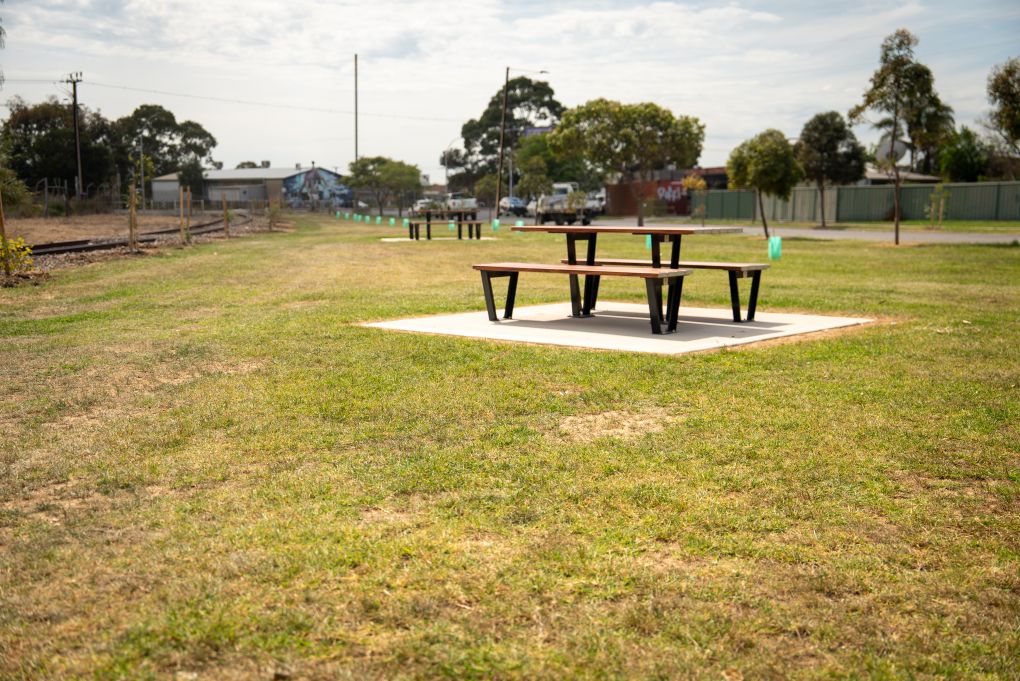 Picnic table on grass at the Rosewater Loop community space