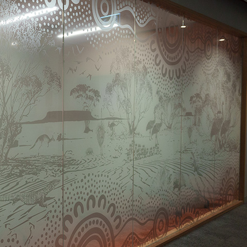 Artwork on meeting room glass walls representing a desert theme.