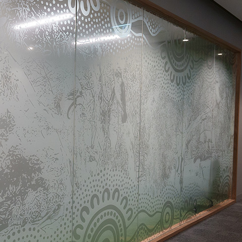 Artwork on meeting room glass walls representing a forest theme.