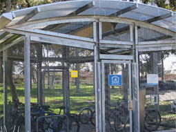 An end-of-trip bike cage with several cycles within.